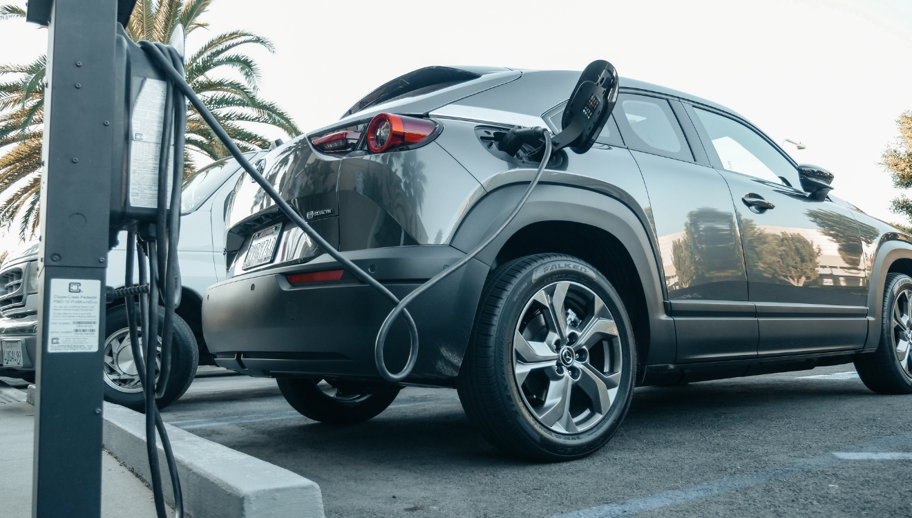 A car being charged at an electric vehicle charging station.