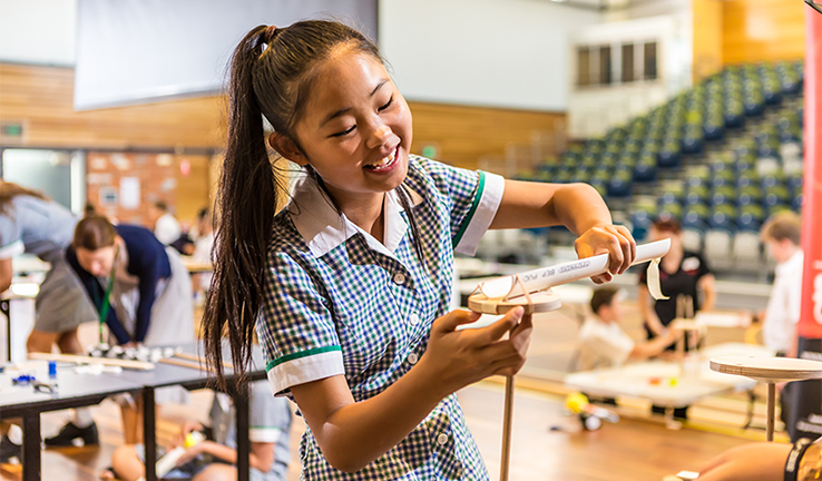 Photo of young girl in a school uniform in a science education program. Photo of young girl in a school uniform in a science education program.