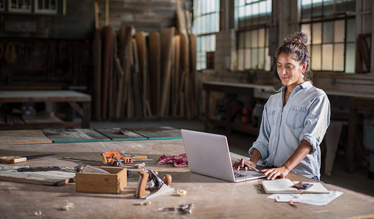 Woman working on laptop on worktable