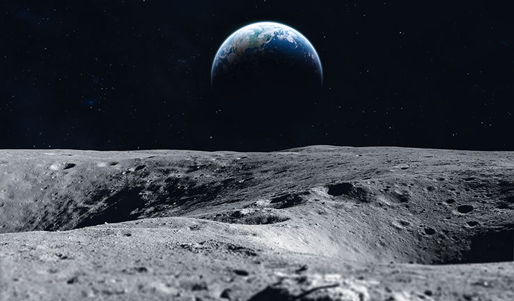 A photo of the surface of the moon, with Earth in the background