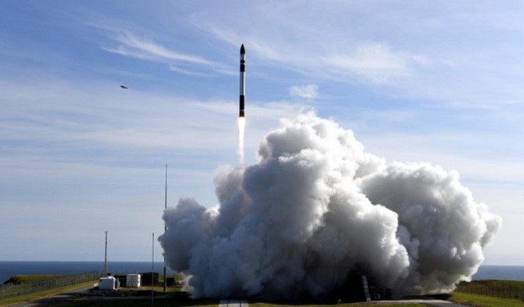 Rocket launching from the ground surrounded by a large cloud of smoke