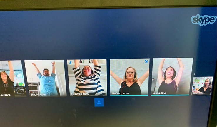 Online yoga with Oiyu A computer screen showing several people doing yoga at their desks