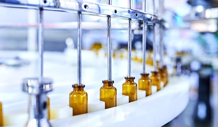 Photo of vials of medicine in a production line Photo of vials of medicine in a production line