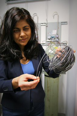 Professor Veena Sahajwalla holding electronic waste