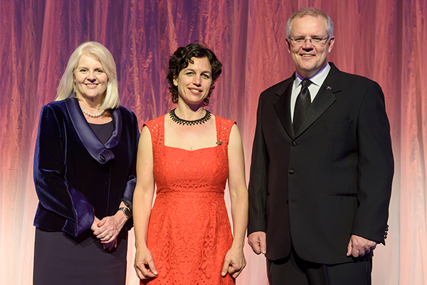 Photo of prize winner accepting award, see captions below.