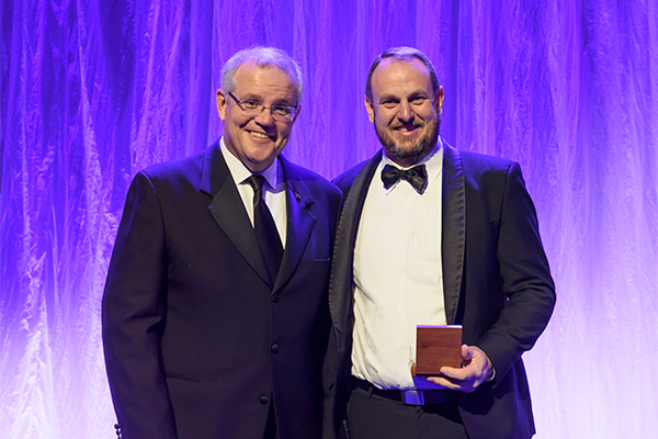 Photo of prize winner accepting award, see captions below.