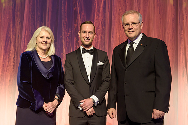 Photo of prize winner accepting award, see captions below.