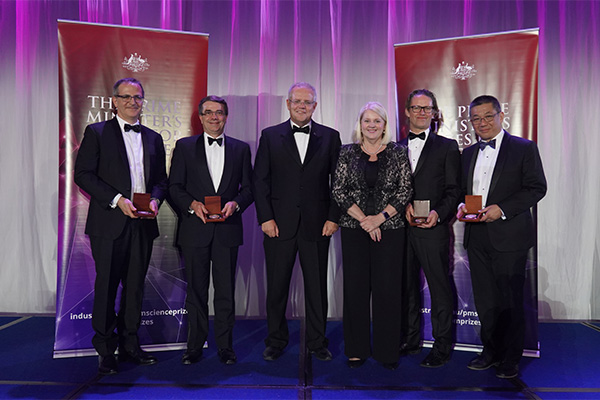 Photo of Walter and Eliza Hall Institute of Medical Research team on stage receiving their award.