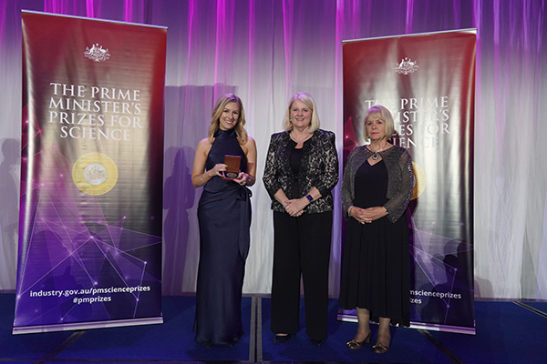 Photo of Professor Laura Mackay on stage receiving her award.