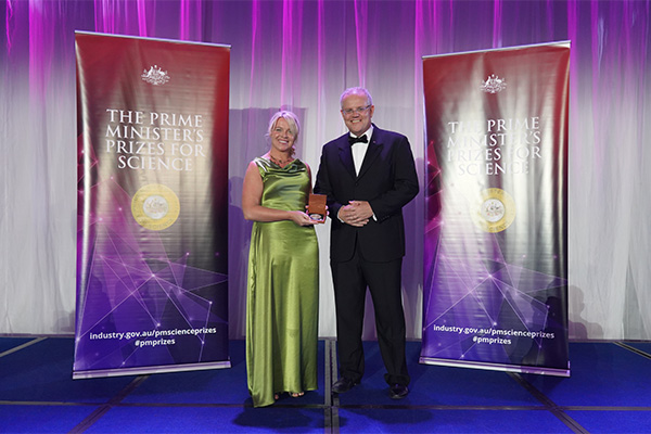 Photo of Dr Samantha Moyle on stage receiving her award.