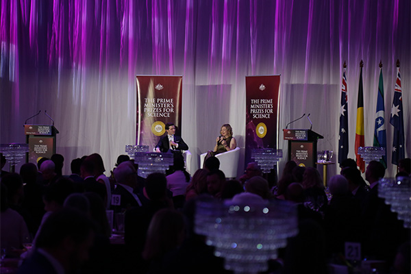 Photo of Tanya Monro on stage sharing her story.