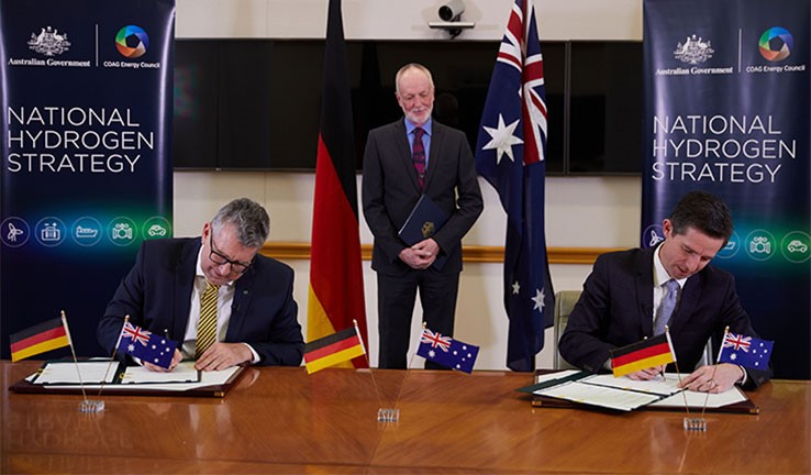 Photo of Australia’s two Ministers signing the agreement, witnessed by his Excellency Dr Thomas Fitschen, who is the ambassador of Germany to Australia.