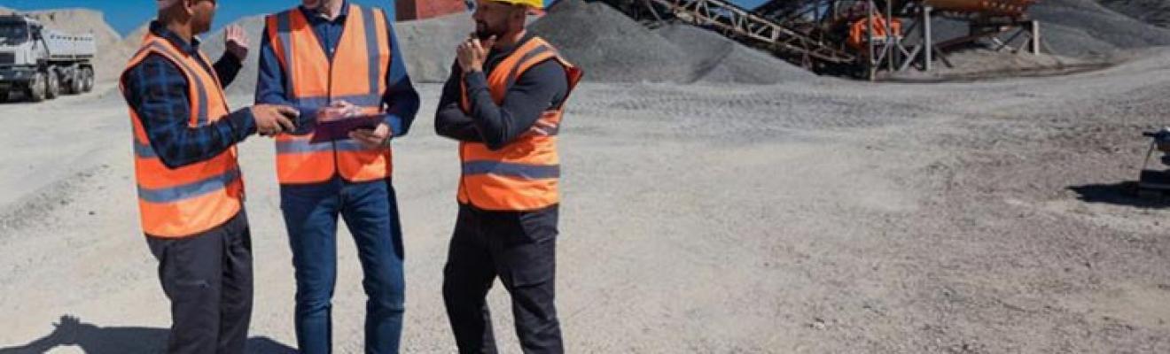 3 people standing in front of a construction site. 