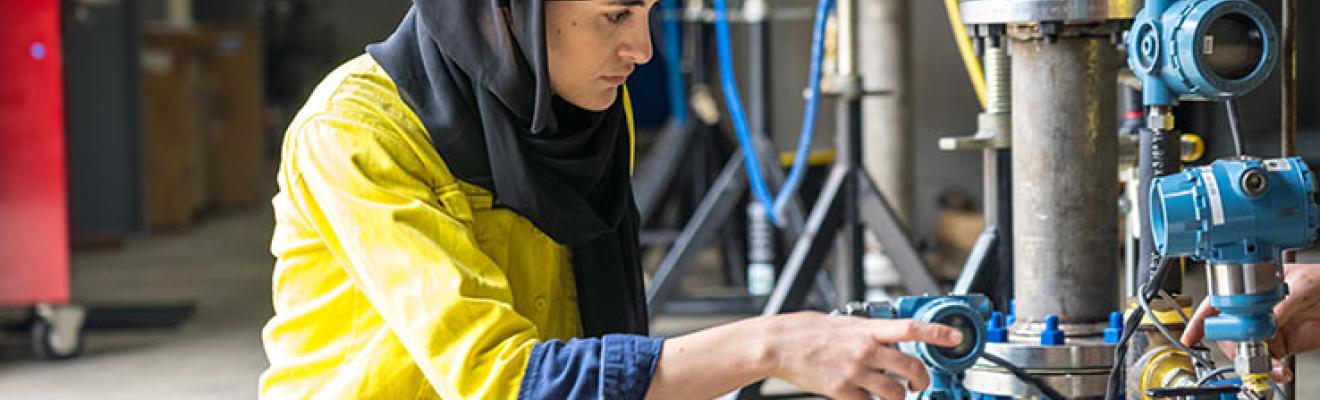 A women working in an industrial setting.