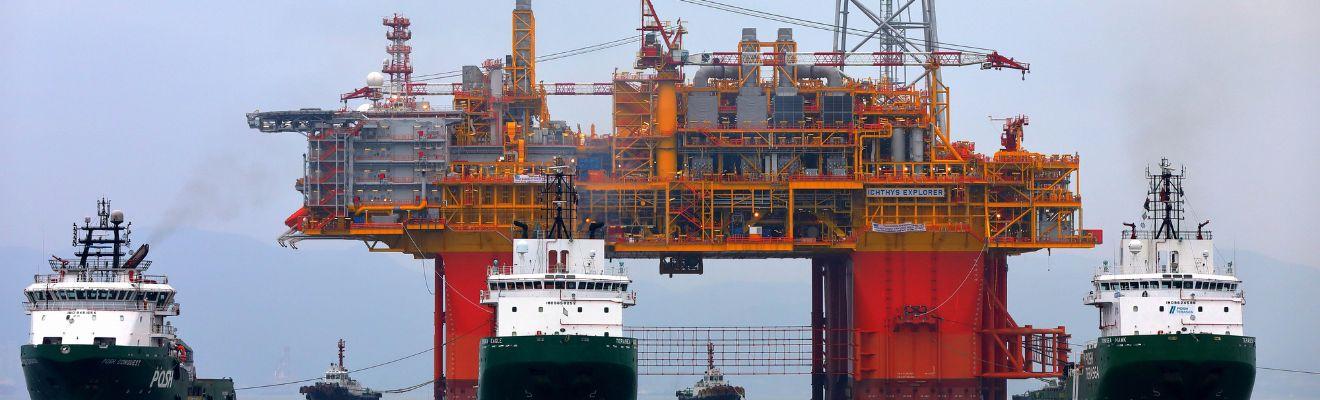 Photo of boats towing a floating oil platform
