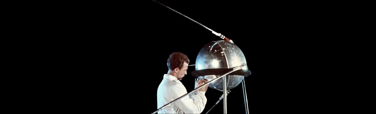 Scientist and sputnik against a black background. 