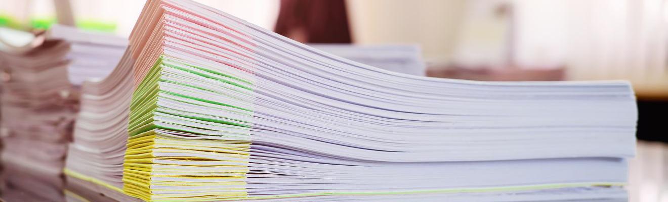 Stack of colour-coded documents on a desk