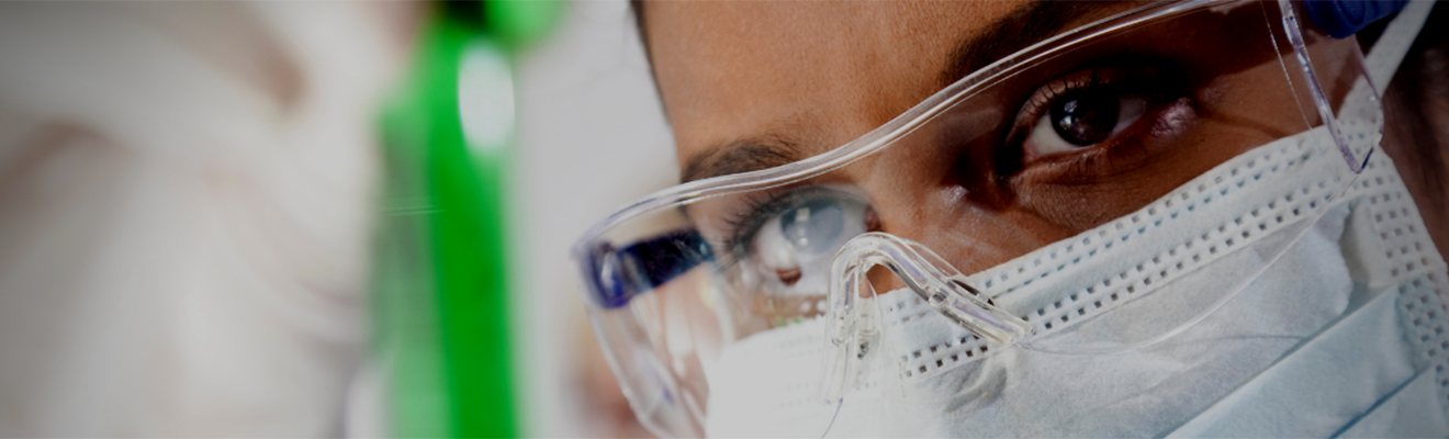 Scientist looking at test tube