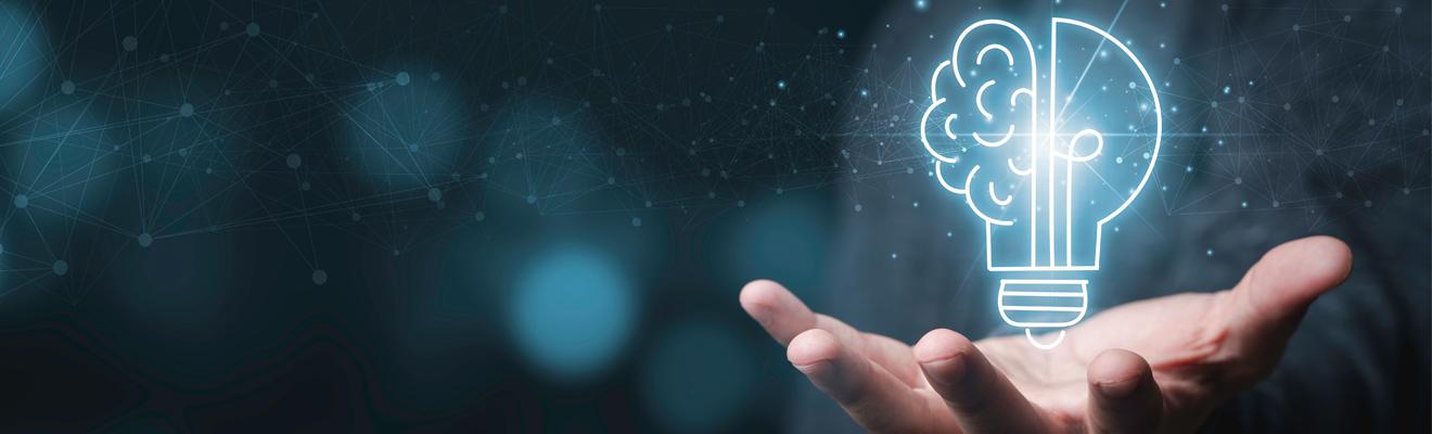 Lightbulb in shape of brain with hand underneath