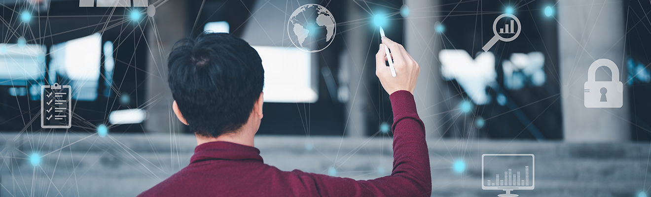 Person stands in front of virtual whiteboard and connects dots between digital symbols 