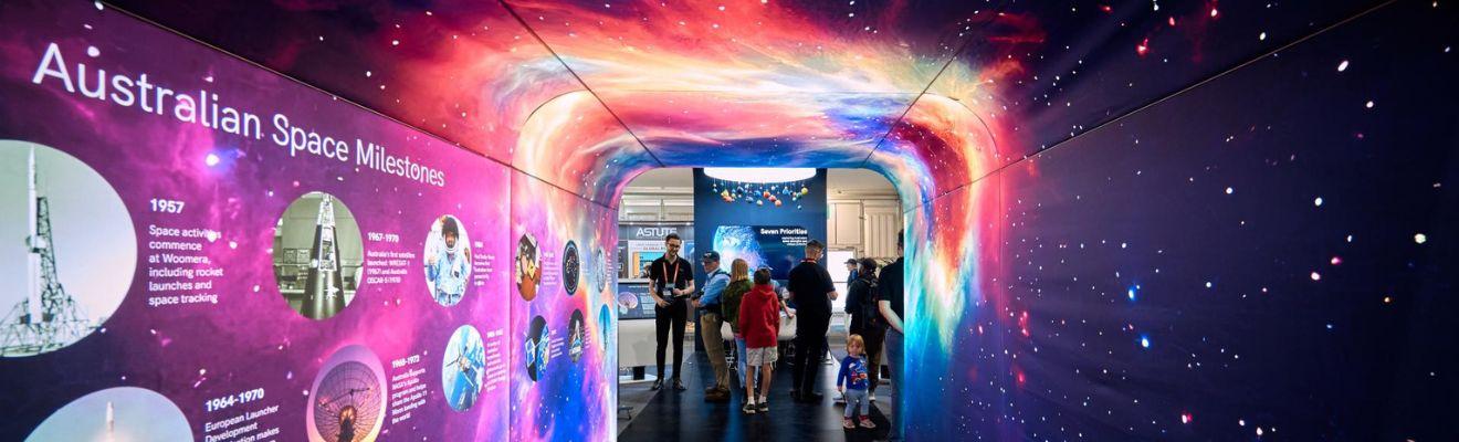 An immersive tunnel experience with Australian space milestones are on one side and the cosmos on the other.