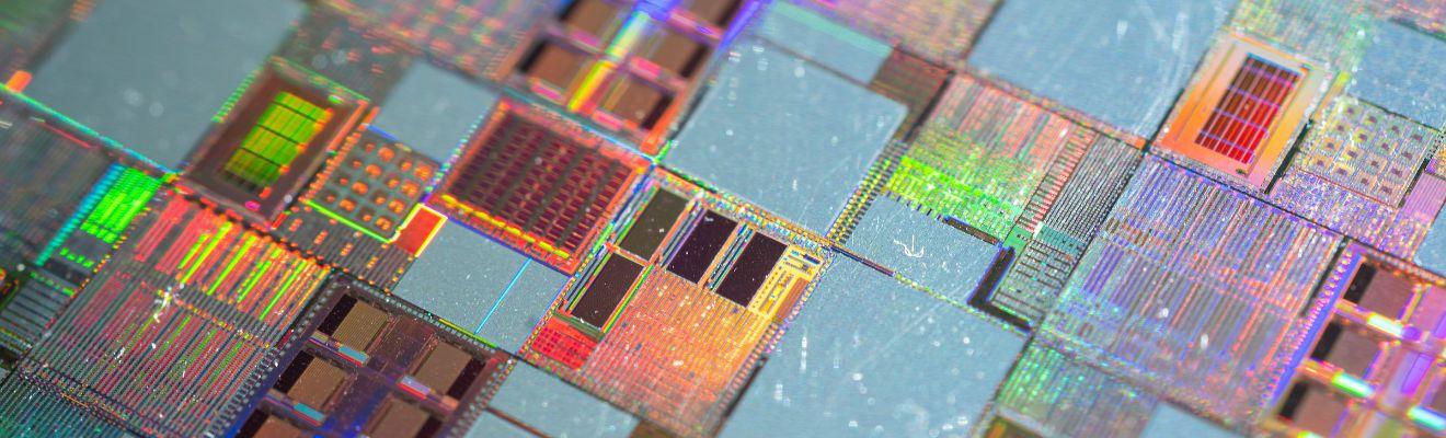 Close up image of semiconductor silicon wafer with text ‘Grant opportunity - International Partnerships in Critical Minerals Program – applications now open’. 