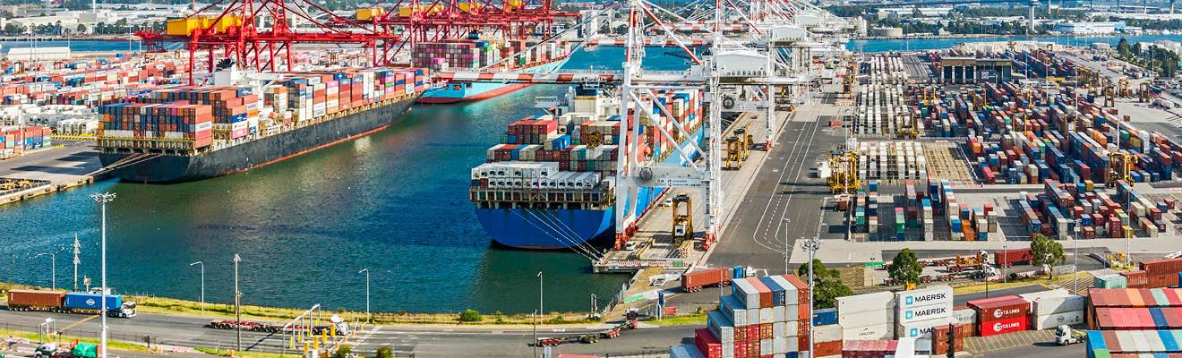 Photo of cargo containers, docked at a shipping yard