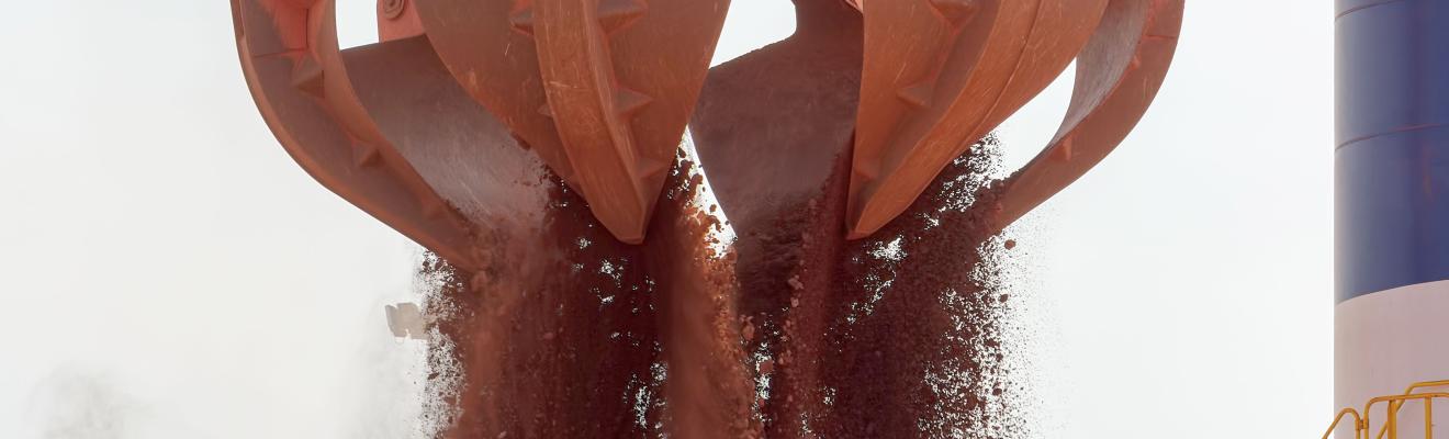 A mining bucket releases its contents