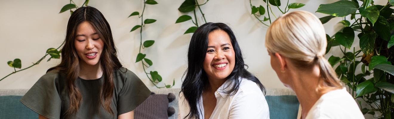 Three women from diverse backgrounds networking. 