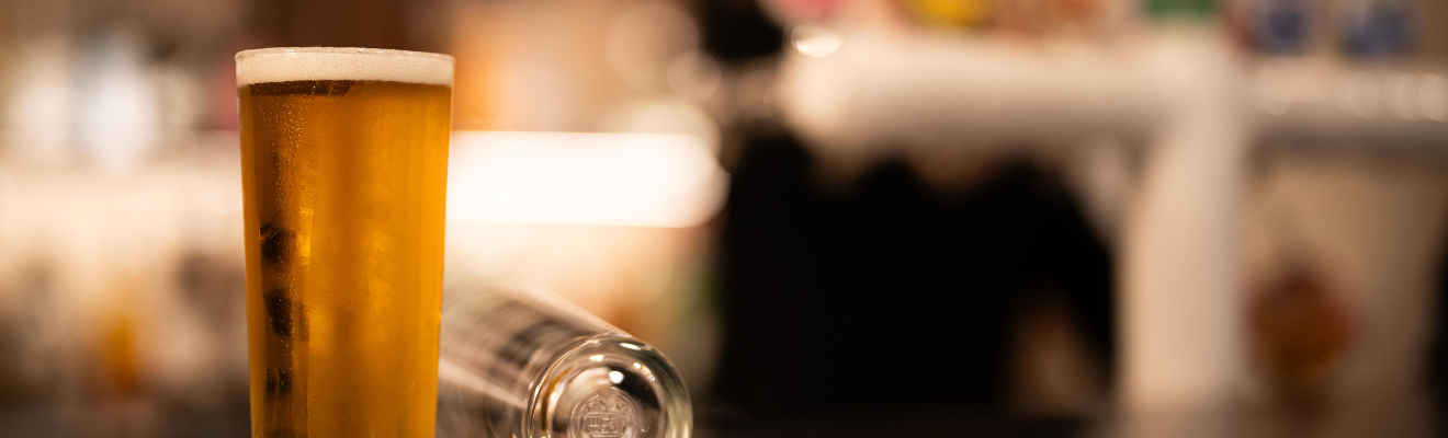 A glass of beer at a bar