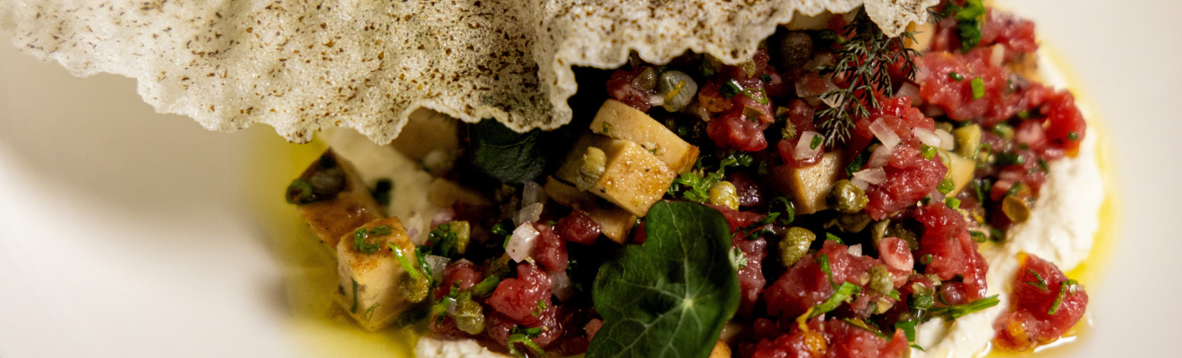 Lab grown forged cultured Japanese quail foie gras is presented on a plate in a restaurant