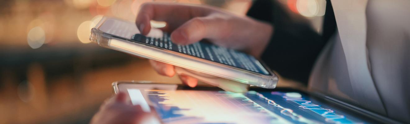 Modern digital tablet showing AI data dashboard and finance chart under ambient light. Represents machine learning, big data visualisation, and smart financial management in the new digital world.