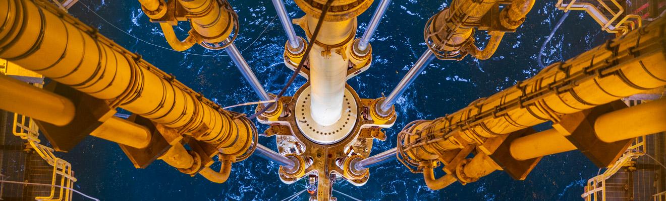 View of drilling equipment from an offshore oil and gas platform looking into the ocean