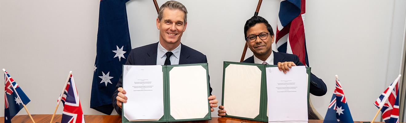 Australia’s Assistant Minister for Science, Technology and the Digital Economy, Dr Andrew Charlton MP and UK Minister for AI and Online Safety, Kanishka Narayan MP hold signed copies of the MoU.