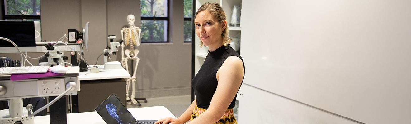A female scientist working on a laptop in a science laboratory.