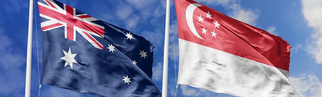Australia and Singapore flags flying against the sky
