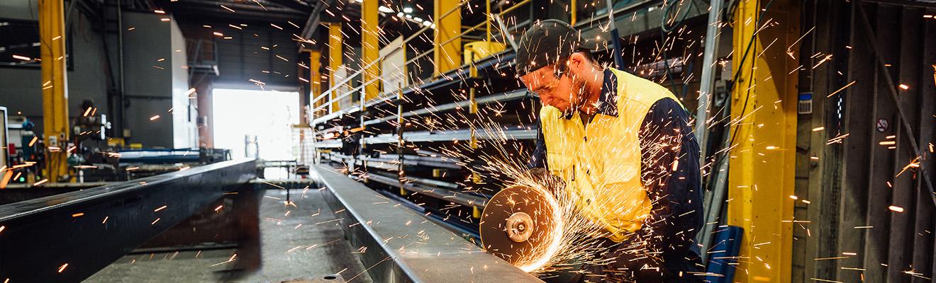 Welder manufacturing goods in a factory