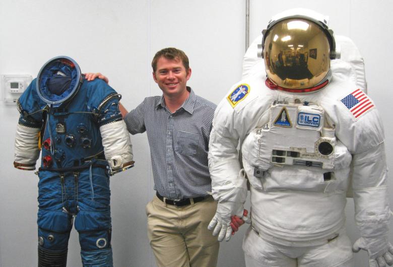 Dr James Waldie, Human Aerospace Director, with NASA Extravehicular Activity suits used for spacewalking