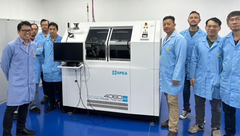 Photo of the team standing beside the tester