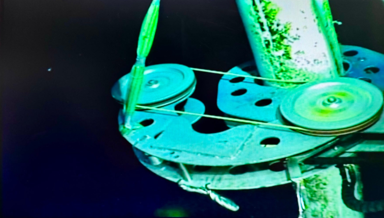 The live feed from the ROV is visible on a monitor as the riser cutting device is preparing to cut