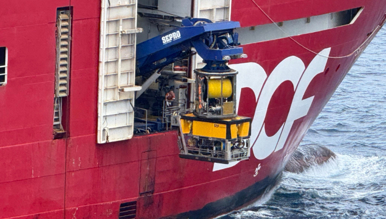 Multi-purpose vessel, Skandi Hercules, lowers a remote operated vehicle (ROV) out of a hanger and into the ocean