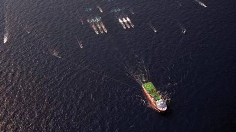 Arial photo of large and small exploration boats in the ocean