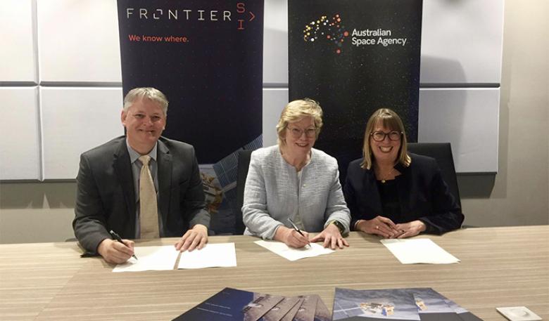 A photo of Frontier and Australian Space Agency leaders signing the statement. A photo of Frontier and Australian Space Agency leaders signing the statement.