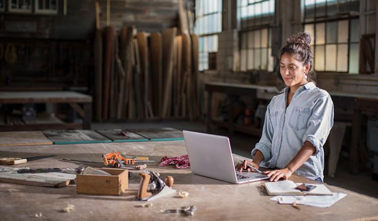 Woman working on laptop on worktable