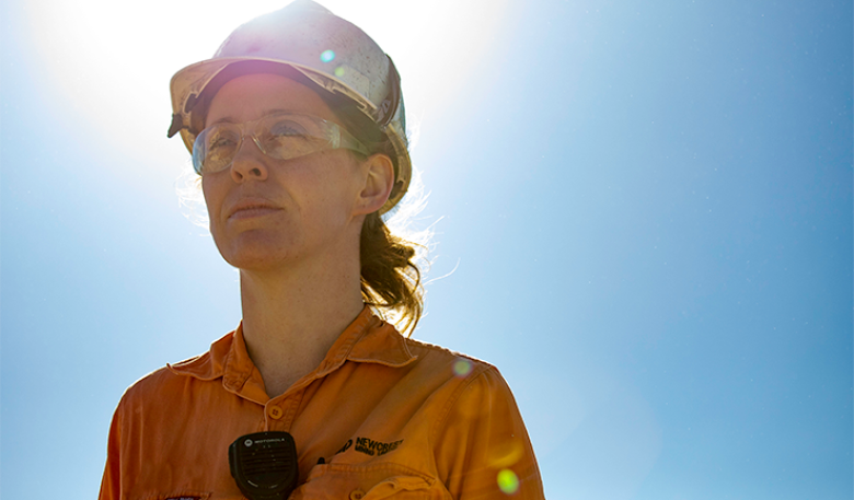Image of a woman miner on a sunny day