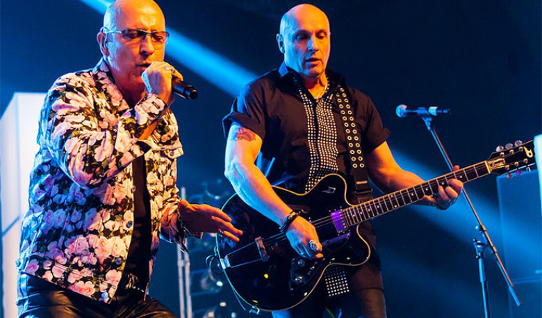 Photo of the band Right Said Fred at a concert. Photo of the band Right Said Fred at a concert.