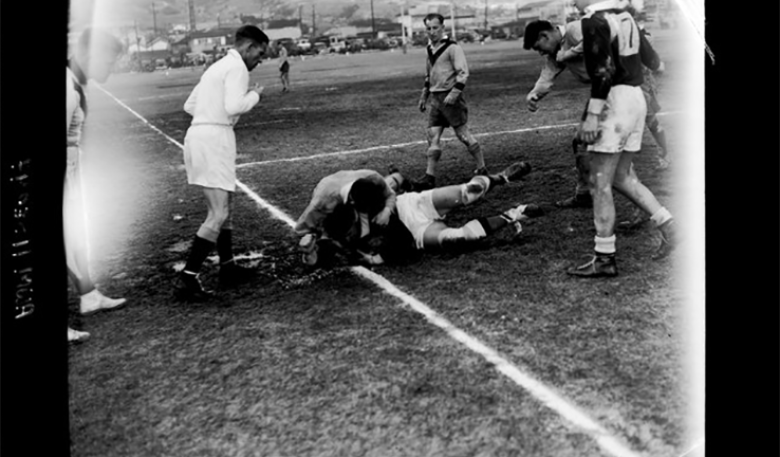 Black and white vintage photo of rugby players and referee on a field. Black and white vintage photo of rugby players and referee on a field.