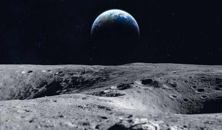 A photo of the surface of the moon, with Earth in the background