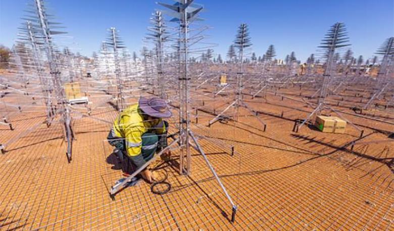 A technician adjusts telescope equipment.