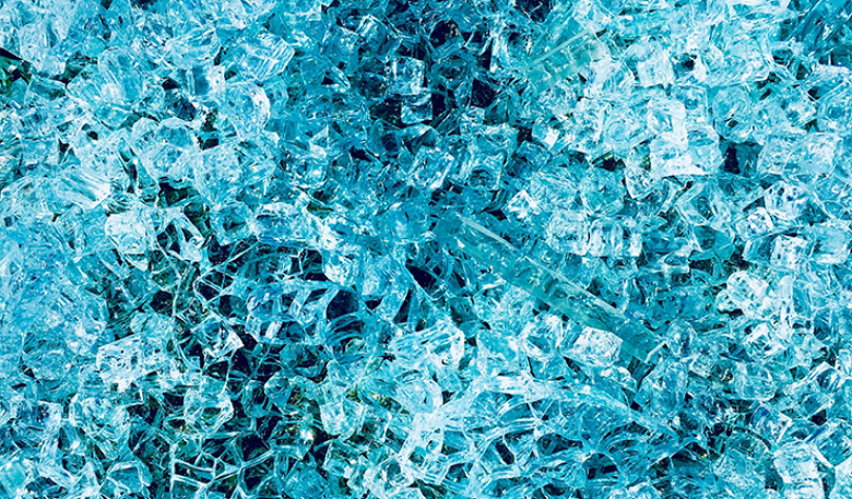 Close up photo of blue crumbled glass.